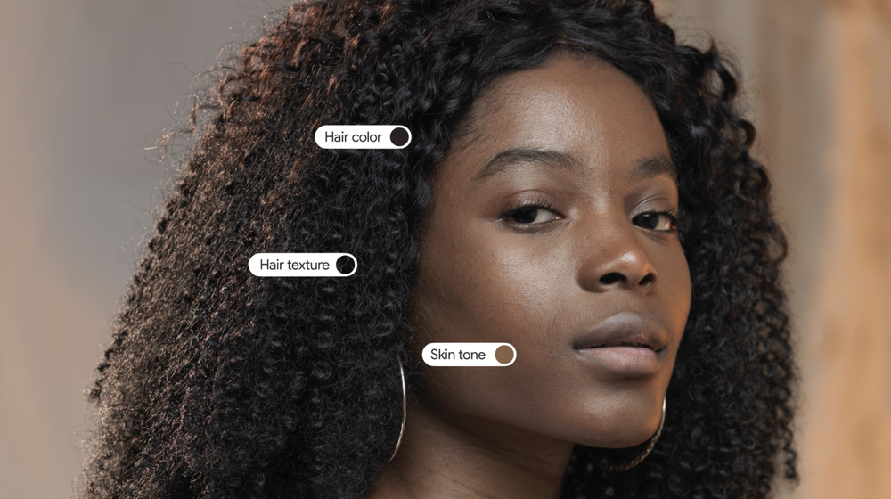 A photograph of a Black person looking into the camera. Tags hover over various areas of the photo; one over their skin says “Skin tone” with a circle matching their skin tone. Two additional tags over their hair read “Hair color” and “Hair texture.